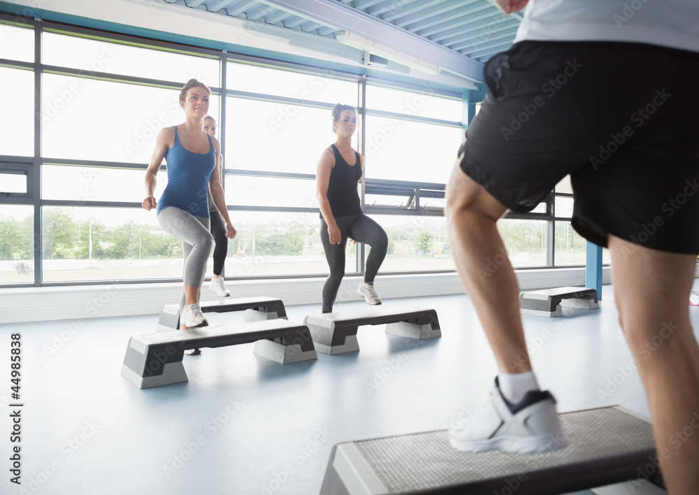 Trainer stepping with aerobic class