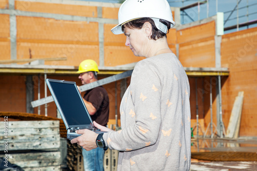 Civil engineer with a laptop on site