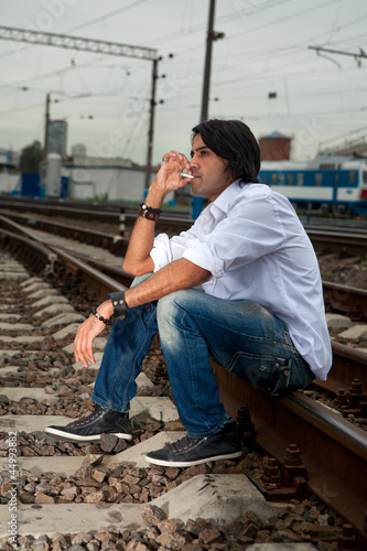 Man is sitting on the rails