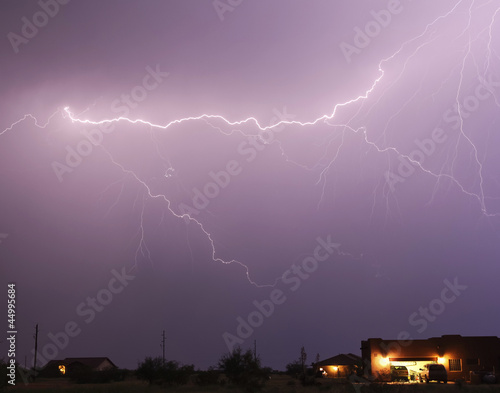 A Lightning Bolt Streaks Above a Neighborhood