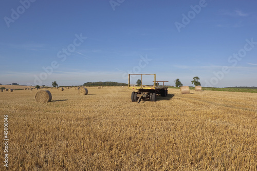 straw bales with a yellow trailer