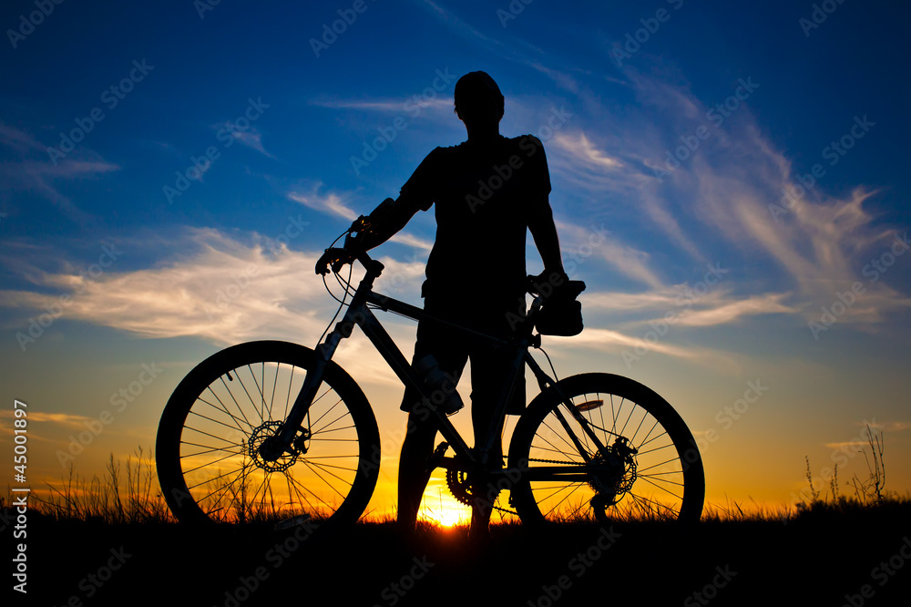 cyclist with a bike silhouette on a sunset sky cyclist with a bike silhouette on a sunset sky