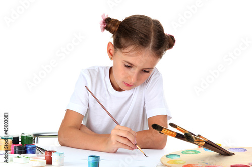 Cute little girl painting a...