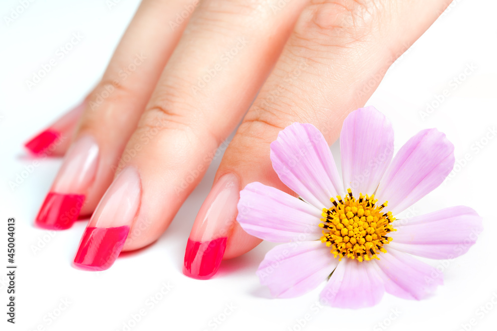Hands with manicure relaxing with flowers