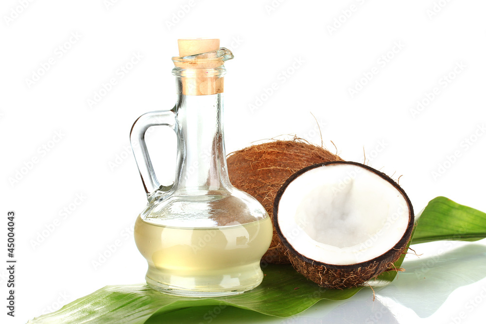 decanter with coconut oil and coconuts isolated on white decanter with coconut oil and coconuts isolated on white