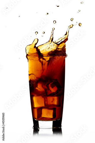 Ice cube droped in cola glass