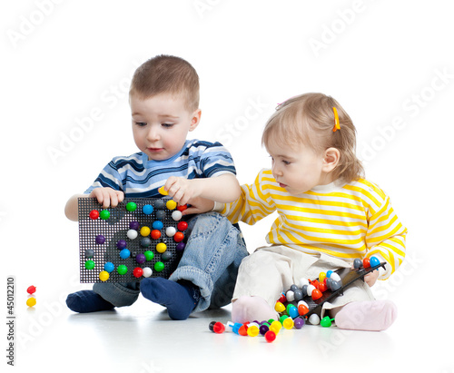 two small children play tog...