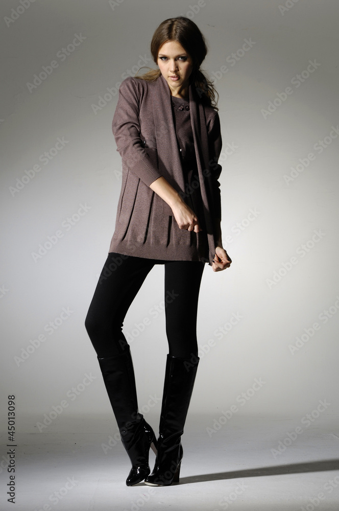 young fashion model posing in light background in the studio young fashion model posing in light background in the studio