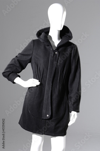 Fashion black Female fur coat on a dummy isolated