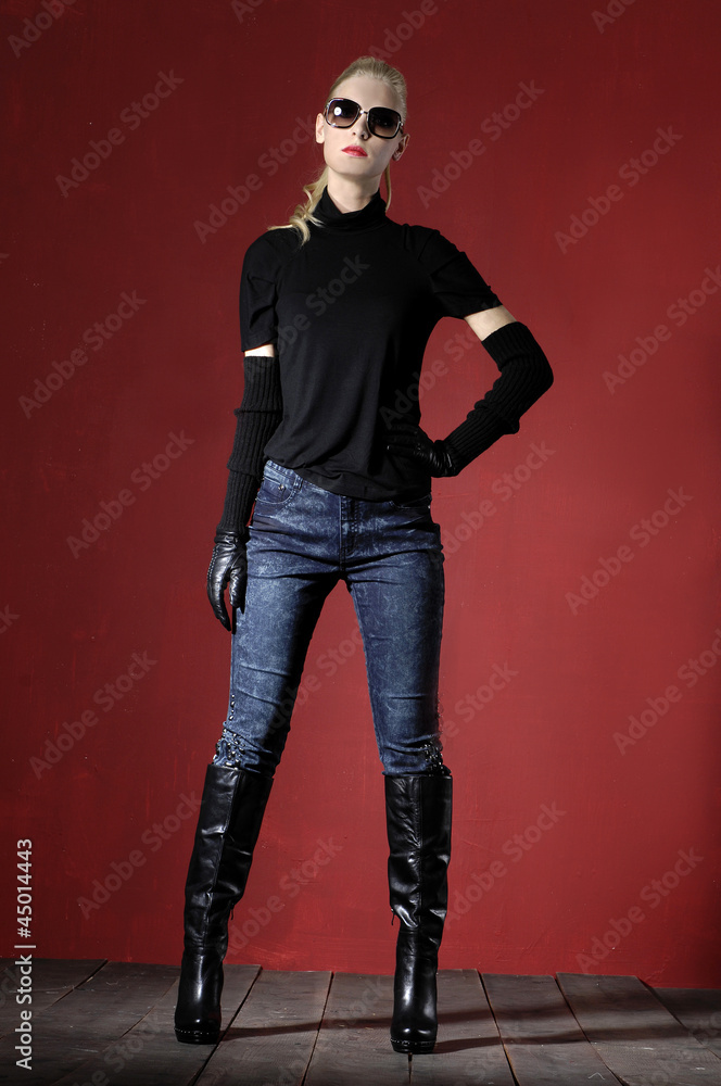 young woman wearing sunglasses against red background young woman wearing sunglasses against red background