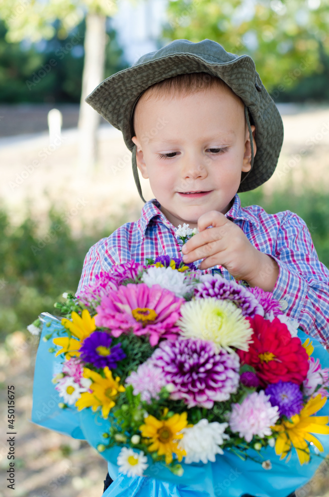 Boy taking a single flower from a bouquet Boy taking a single flower from a bouquet