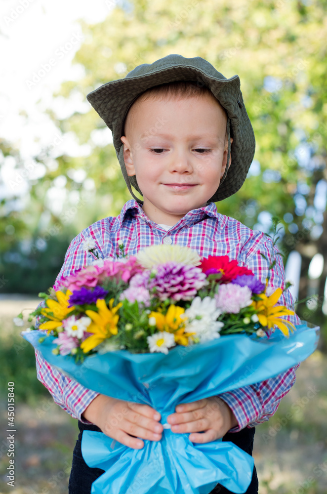 Smiling child presenting flowers Smiling child presenting flowers