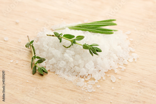 salt with fresh rosemary and and thyme on wooden background