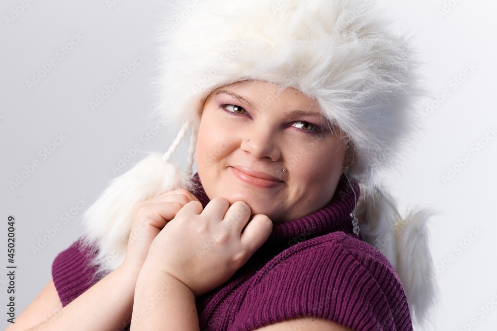 Portrait of plump woman in white fur hat