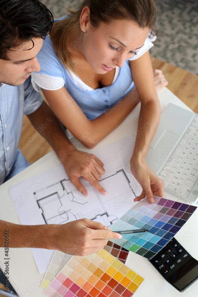 Upper view of couple looking at colour chart Upper view of couple looking at colour chart