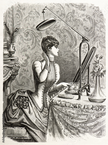 elegant woman looking at mirror. engraved illustration 1885