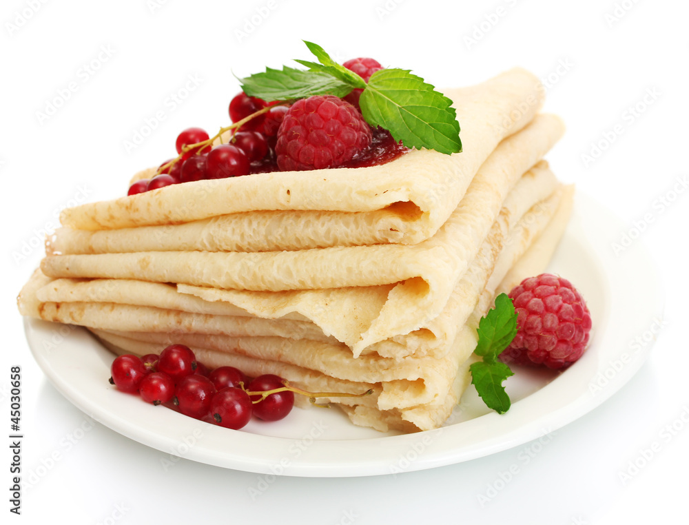 Delicious pancakes with berries and jam on plate on wooden Delicious pancakes with berries and jam on plate on wooden