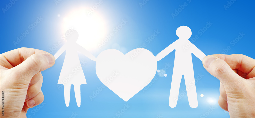paper family with heart in hands paper family with heart in hands