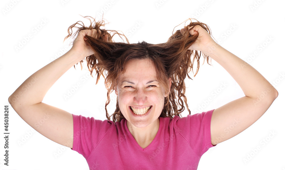 Young smiling tearing her hair out Young smiling tearing her hair out