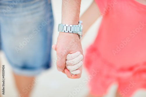 Father and daughter holding hands