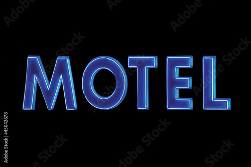 Blue Neon Motel sign at night, isolated