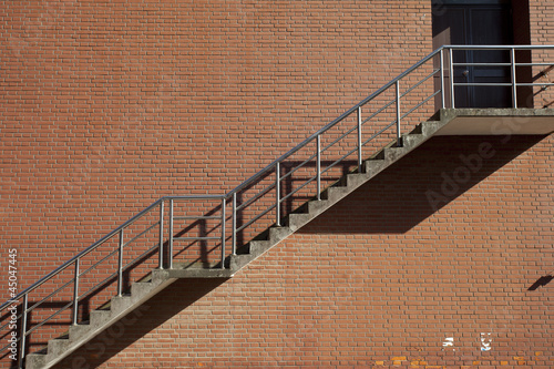 steel Grunge stair on the red wall