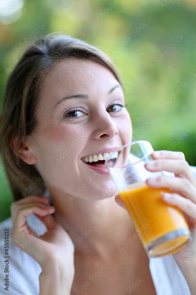Closeup of woman drinking orange juice from glass Closeup of woman drinking orange juice from glass