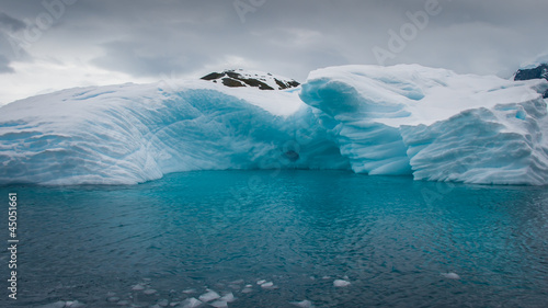 Iceberg drifting in the aquamarine sea of Antarctica