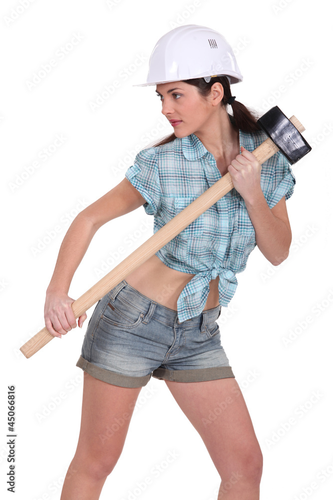 Sexy construction worker with a sledgehammer. Sexy construction worker with a sledgehammer.