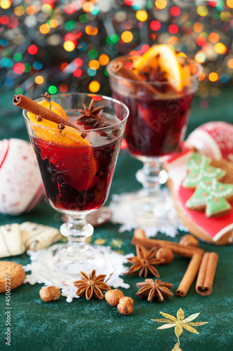 Two glasses of mulled wine, cookies and variation of Christmas s