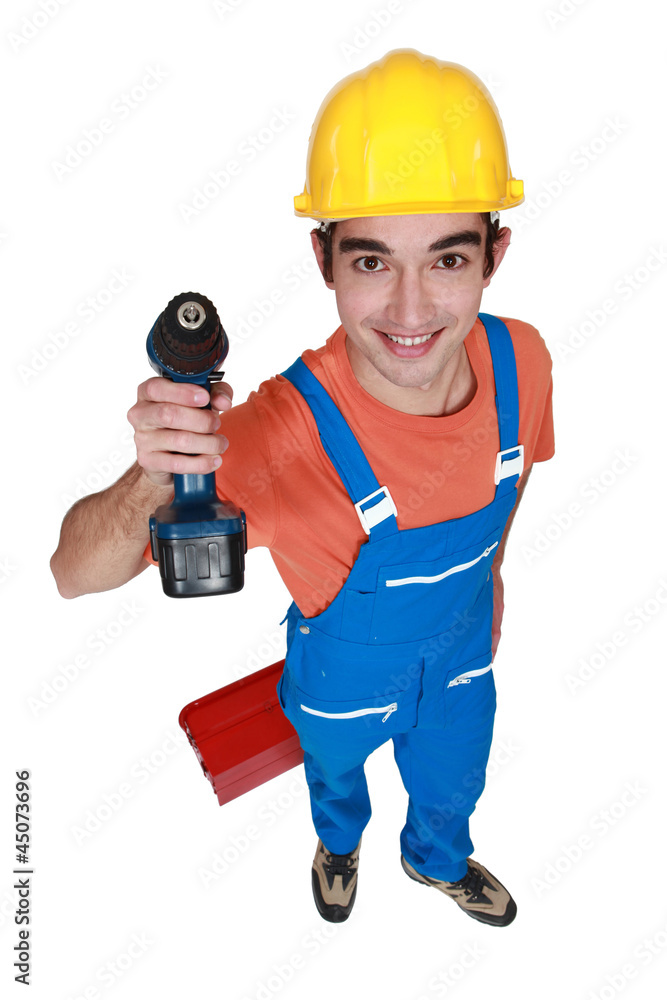 Young carpenter stood with cordless drill Young carpenter stood with cordless drill
