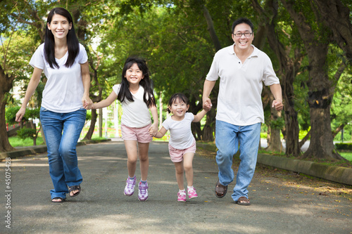 happy asian family walking on the road