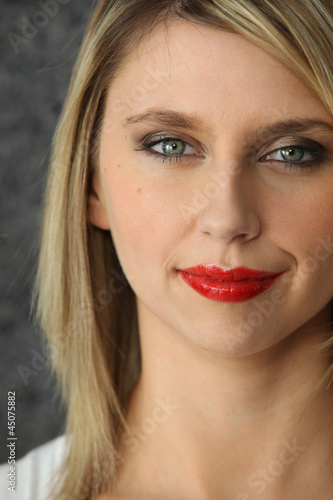 Head-shot of blond woman wearing red-lipstick