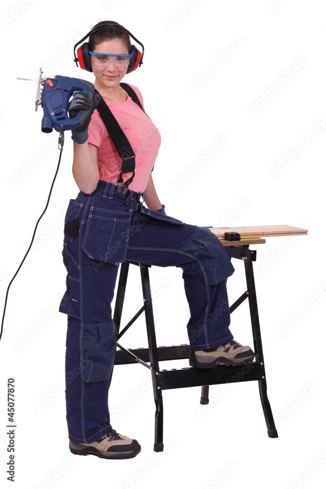 Women with a chainsaw cutting wood