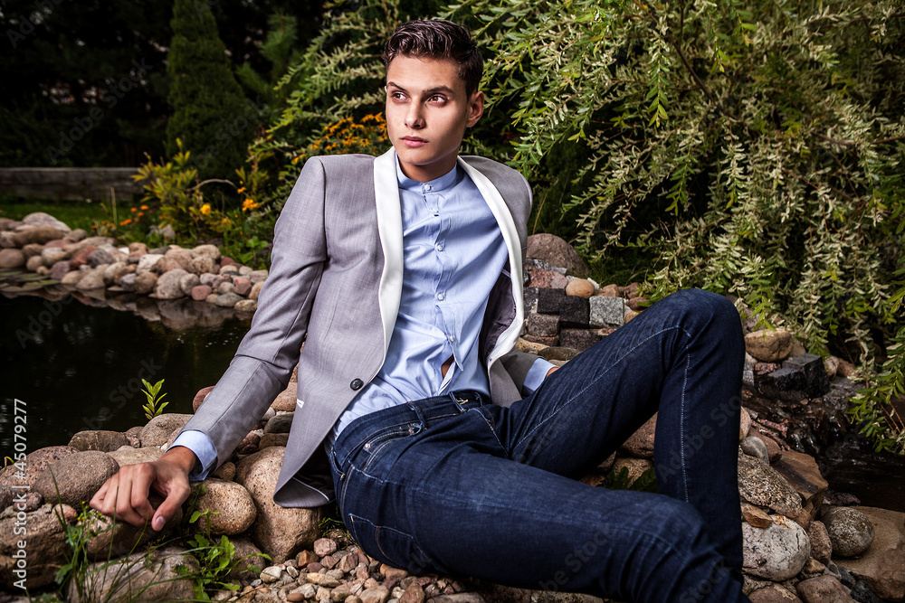 young beautiful fashionable man against autumn garden. young beautiful fashionable man against autumn garden.