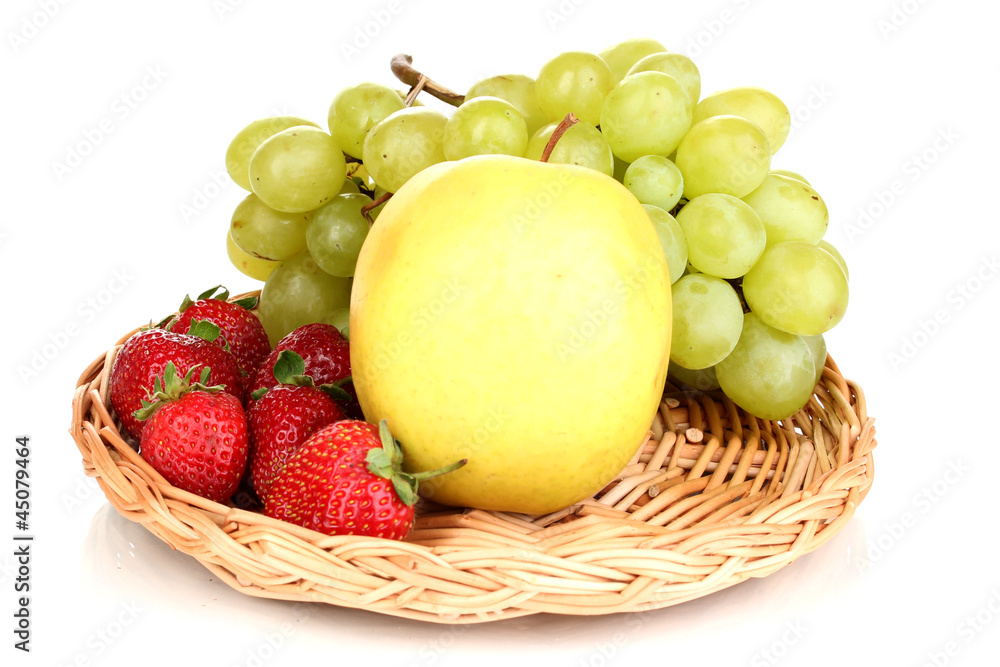 ripe sweet fruits and berries on wicker mat isolated on white