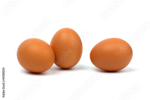 Three eggs closeup isolated on white background.