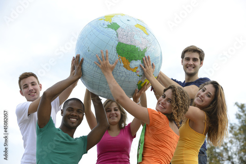 Group of young people holding a globe earth photo