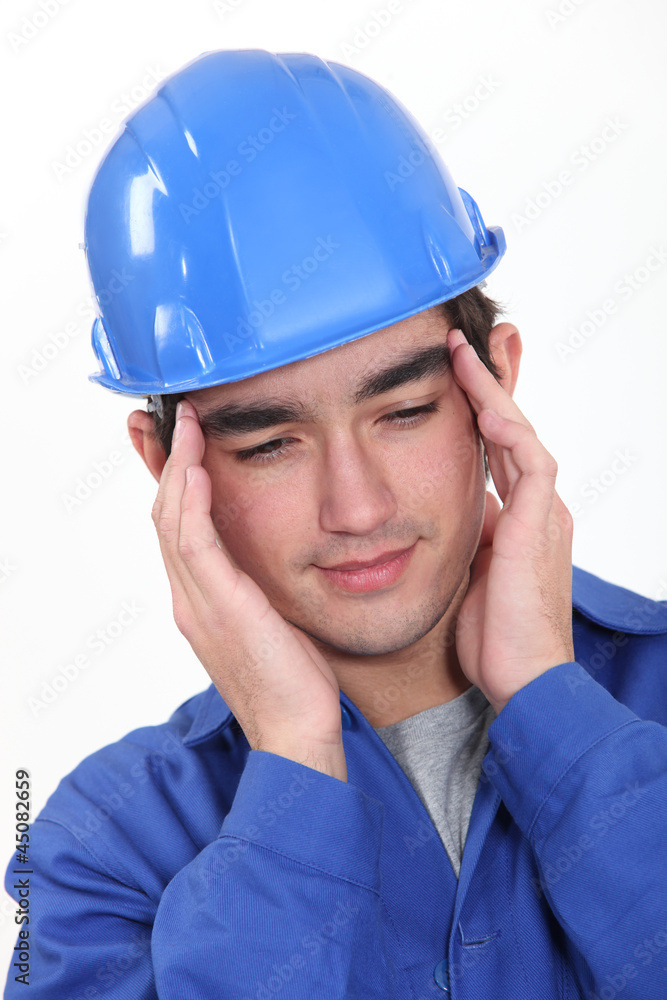 Builder suffering from tension headache Builder suffering from tension headache