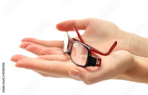 glasses on female hands, isolated on white