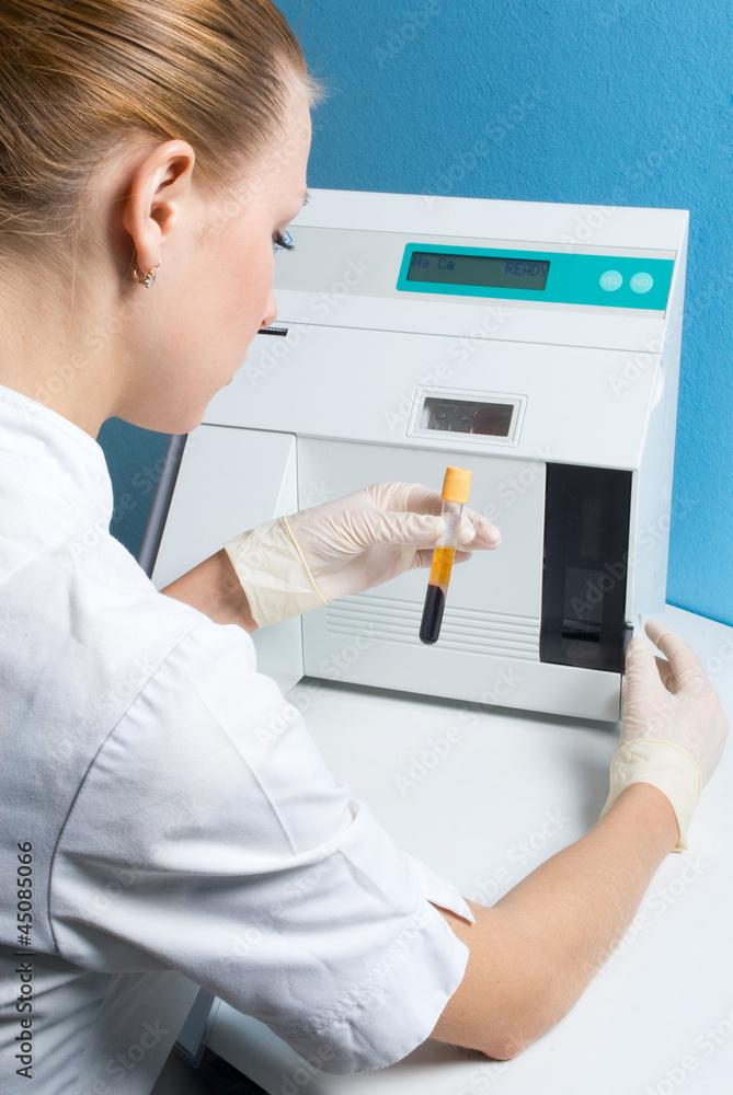 The woman physician behind work in laboratory The woman physician behind work in laboratory
