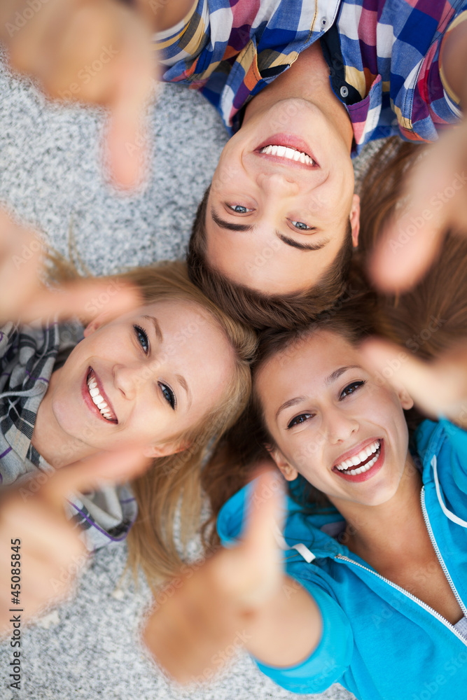 Fototapeta premium Young people with thumbs up