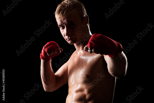 man boxing against black background © ArtFamily