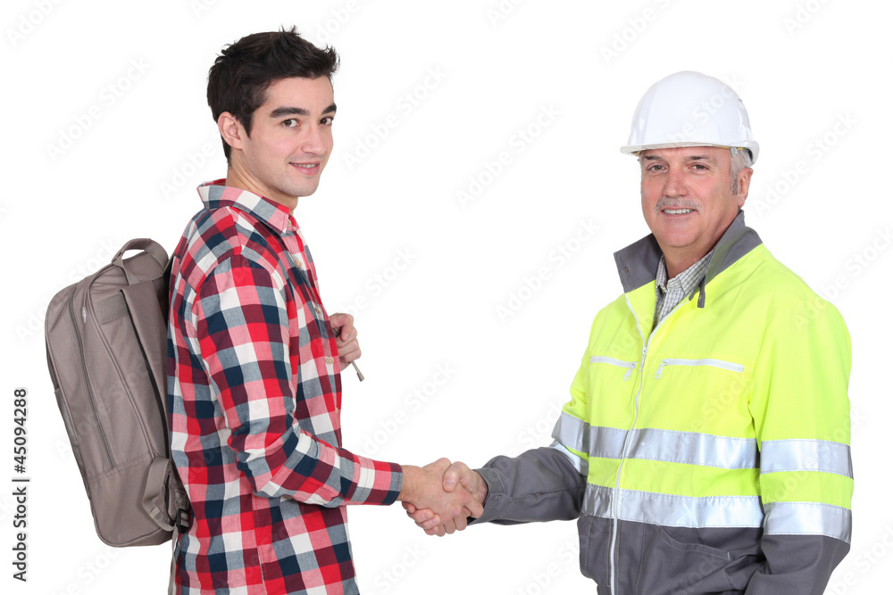 young apprentice shaking hands with senior foreman young apprentice shaking hands with senior foreman
