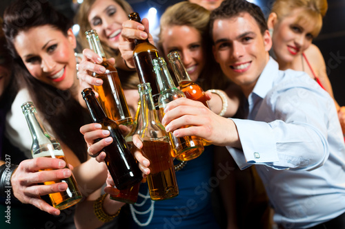 People in club or bar drinking beer © Kzenon