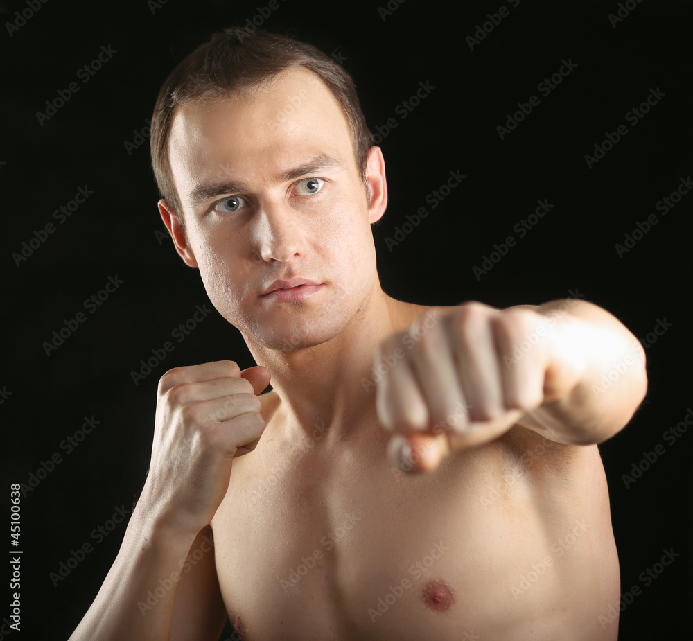 Portrait of boxer on black background