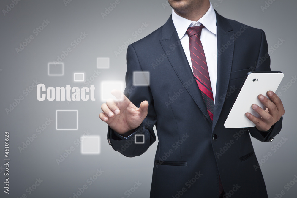 Businessman with tablet pushing on a contact button Businessman with tablet pushing on a contact button