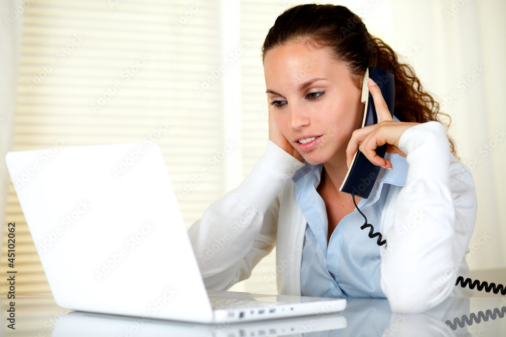 Tired young woman with headache speaking on phone Tired young woman with headache speaking on phone