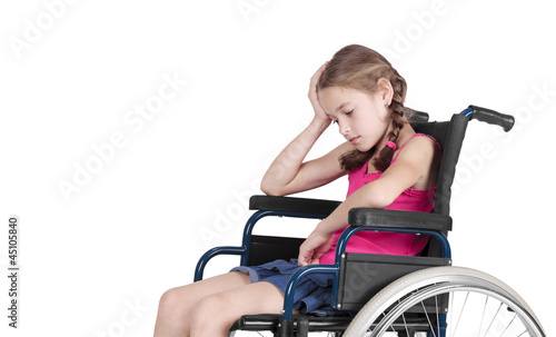 Very sad handicapped girl in a wheelchair over white background