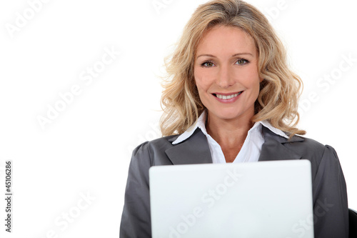 Portrait of blonde woman with computer